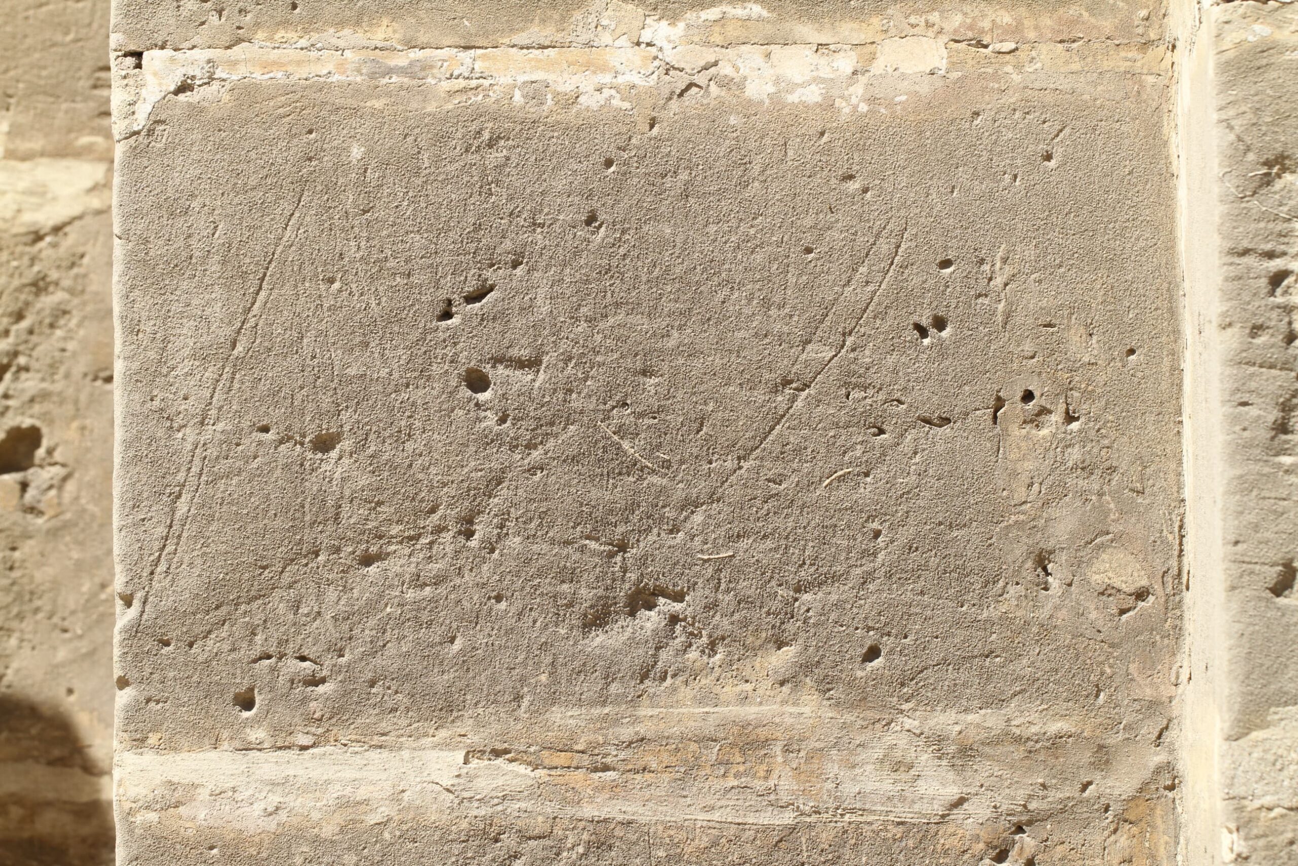 Etchings that bear evidence of a ship graffito that has now eroded away from sight.