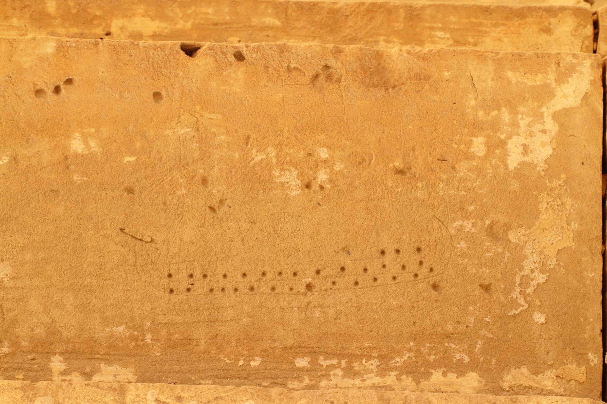 Dot decoration is visible on this ship graffito. The rigging is disappearing over time, however, one can note the presence of masts and flags.