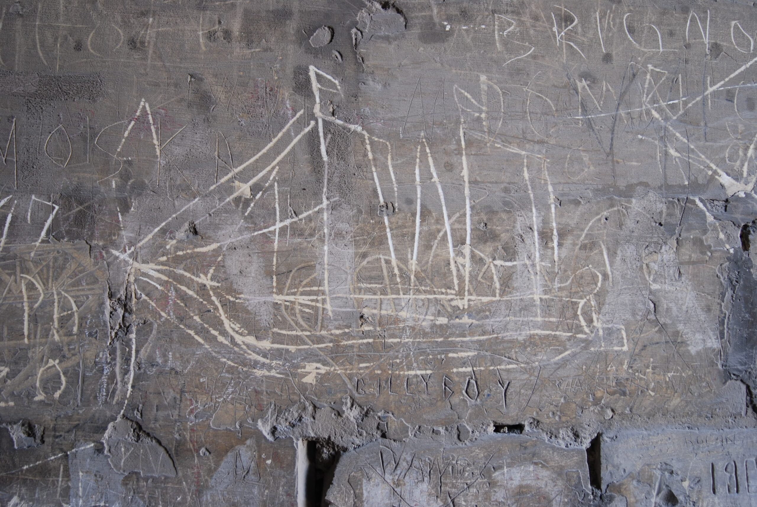 A third of the surface-etched steam and sail ship graffito.